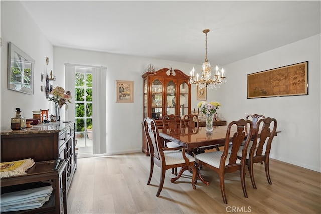 11806 Thunderbird Ave, Porter Ranch, CA 91326 - dining room featuring light wood-type flooring, a chandelier, and baseboards