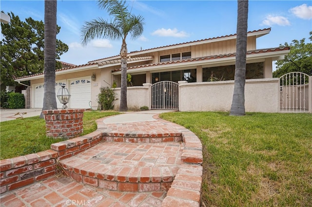 11806 Thunderbird Ave, Porter Ranch, CA 91326 - view of front of house with a gate, a garage, a tiled roof, concrete driveway, and stucco siding