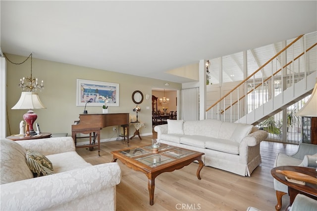 11806 Thunderbird Ave, Porter Ranch, CA 91326 - living room featuring a chandelier, stairway, light wood finished floors, and baseboards