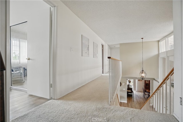 11806 Thunderbird Ave, Porter Ranch, CA 91326 - corridor with an upstairs landing, a chandelier, a textured ceiling, and wood finished floors