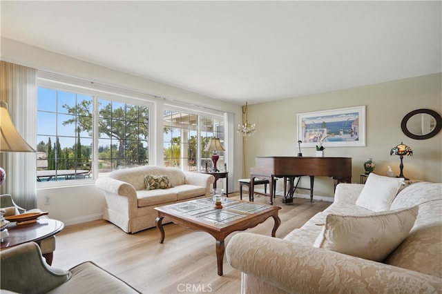 11806 Thunderbird Ave, Porter Ranch, CA 91326 - living room with light wood-type flooring, baseboards, and a chandelier