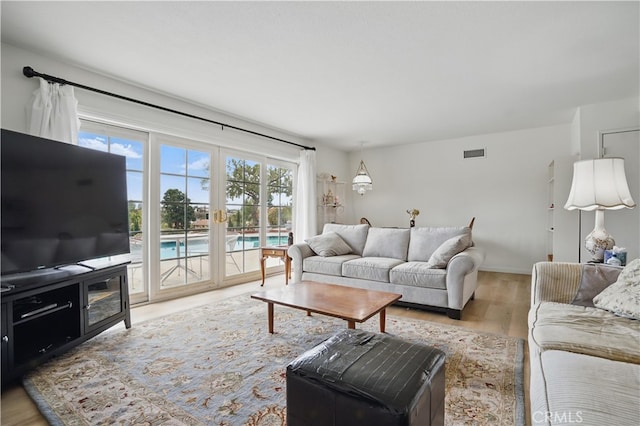 11806 Thunderbird Ave, Porter Ranch, CA 91326 - living area featuring wood finished floors and french doors
