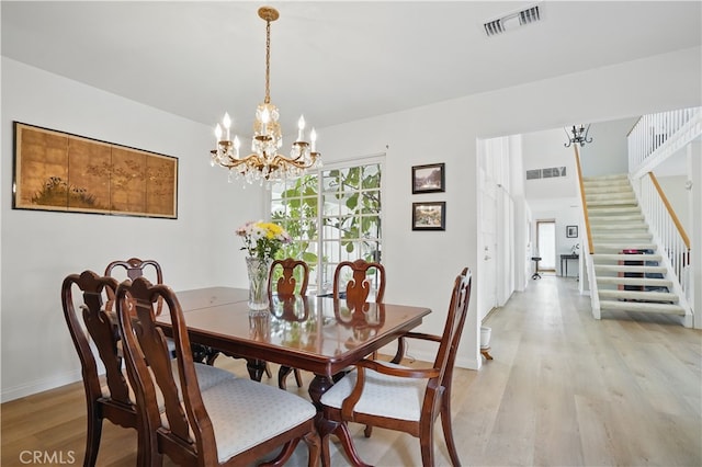 11806 Thunderbird Ave, Porter Ranch, CA 91326 - dining room featuring a chandelier, light wood-style flooring, stairs, and baseboards
