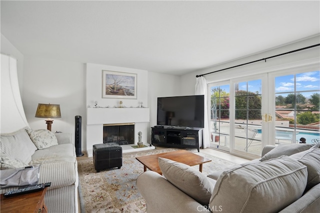 11806 Thunderbird Ave, Porter Ranch, CA 91326 - living area with a fireplace with raised hearth, french doors, and wood finished floors