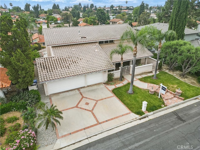 11806 Thunderbird Ave, Porter Ranch, CA 91326 - view of front facade with a tiled roof, concrete driveway, a front yard, stucco siding, and an attached garage