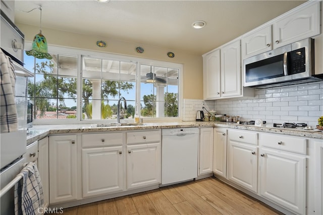 11806 Thunderbird Ave, Porter Ranch, CA 91326 - kitchen featuring white appliances, a sink, tasteful backsplash, white cabinets, and light wood finished floors