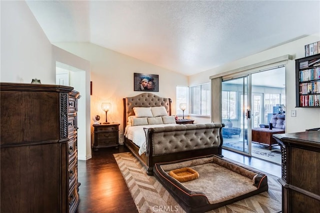 bedroom featuring access to exterior, vaulted ceiling, dark wood-style flooring, and baseboards
