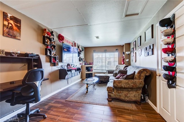 living area with wood finished floors and baseboards