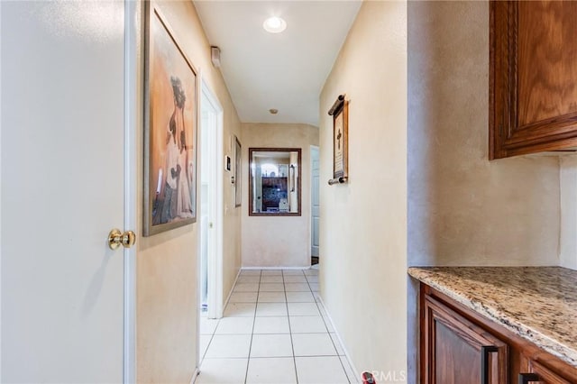 hall with light tile patterned floors