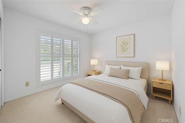 carpeted bedroom featuring baseboards and a ceiling fan