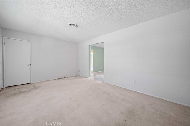 unfurnished room featuring carpet floors and a textured ceiling