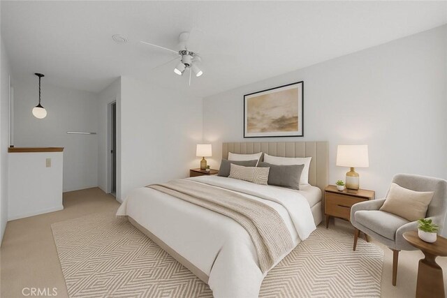 bedroom with light carpet and a ceiling fan