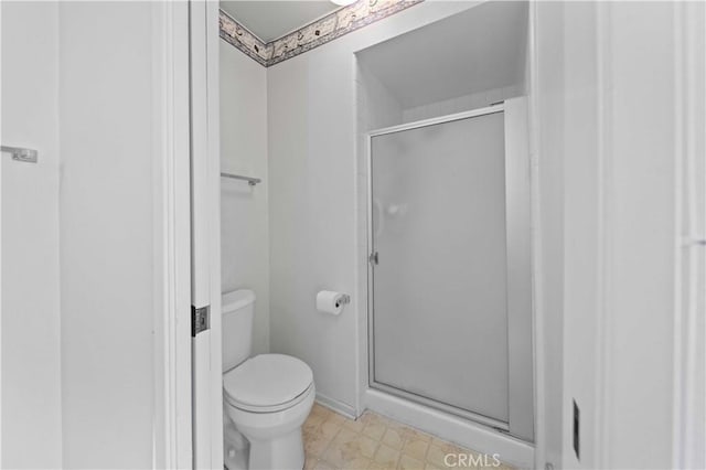 full bath with a stall shower and toilet