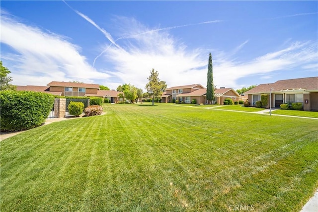 view of green lawn with a residential view