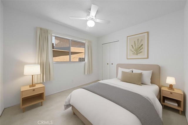 bedroom featuring carpet floors, a closet, ceiling fan, and baseboards