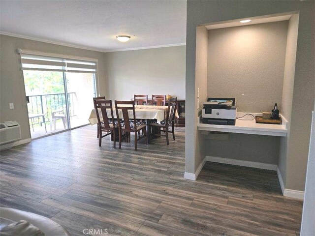 dining area featuring ornamental molding, dark wood-style floors, baseboards, and an AC wall unit