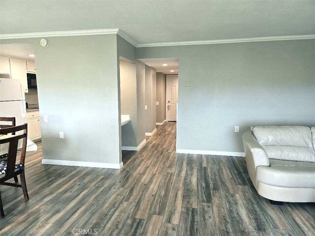 living area with ornamental molding, baseboards, and dark wood-style flooring