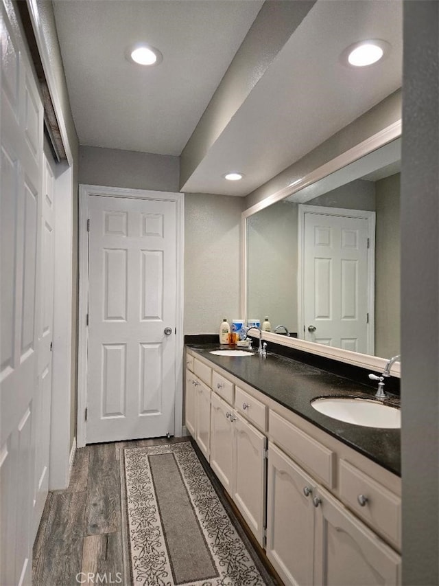 3364 Punta Alta D, Laguna Woods, CA 92637 - bathroom featuring wood finished floors, double vanity, and recessed lighting
