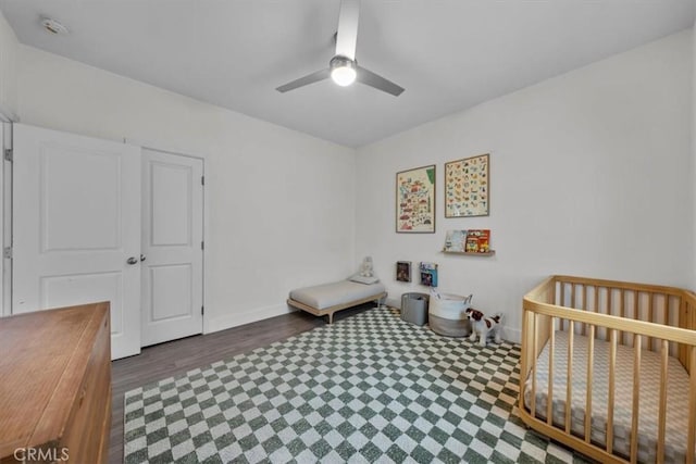 354 E 111th St, Los Angeles, CA 90061 - bedroom with a ceiling fan, wood finished floors, baseboards, and a crib