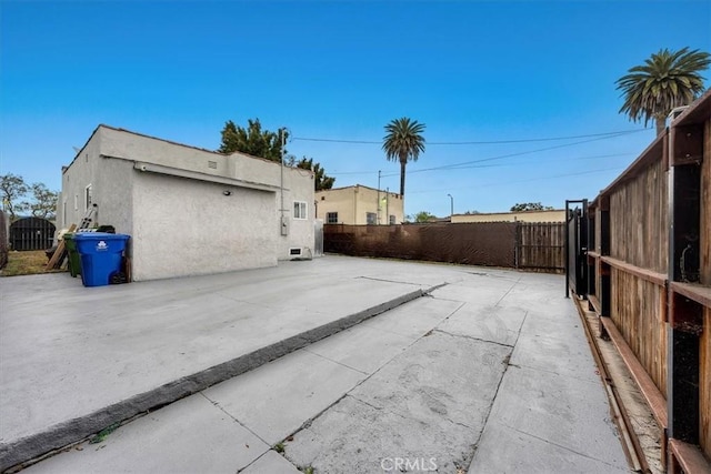 354 E 111th St, Los Angeles, CA 90061 - view of side of property with stucco siding and a patio