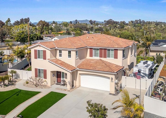 view of front facade featuring a tile roof, stucco siding, driveway, and an attached garage