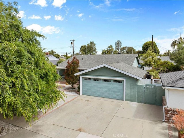 6911 E 10th St, Long Beach, CA 90815 - view of front of home with a garage, a shingled roof, fence, and stucco siding