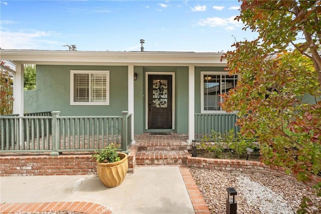 6911 E 10th St, Long Beach, CA 90815 - view of exterior entry featuring a porch and stucco siding