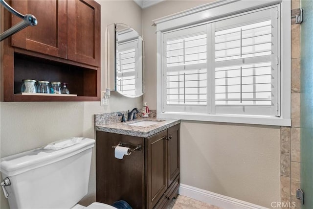 6911 E 10th St, Long Beach, CA 90815 - bathroom featuring toilet, vanity, and baseboards