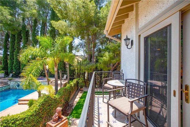 balcony featuring view of pool area