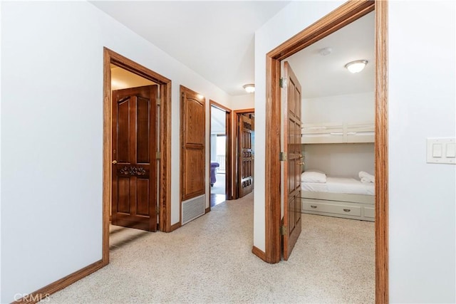 hall featuring carpet and baseboards