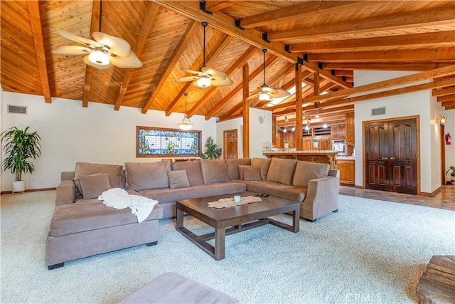 living room with light carpet, a ceiling fan, beamed ceiling, wooden ceiling, and baseboards