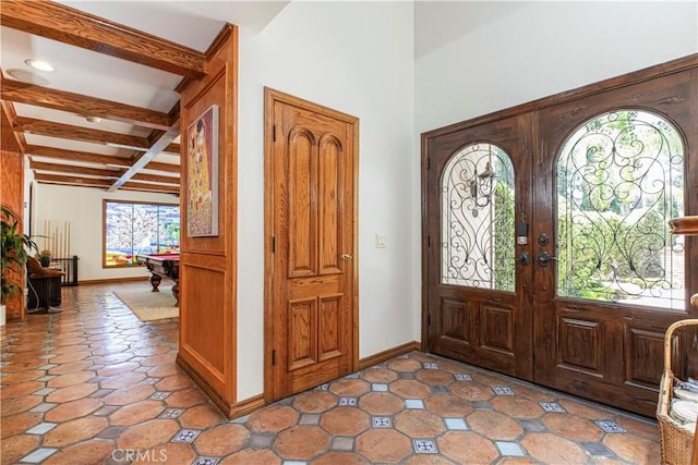 entrance foyer with beamed ceiling, french doors, coffered ceiling, and baseboards