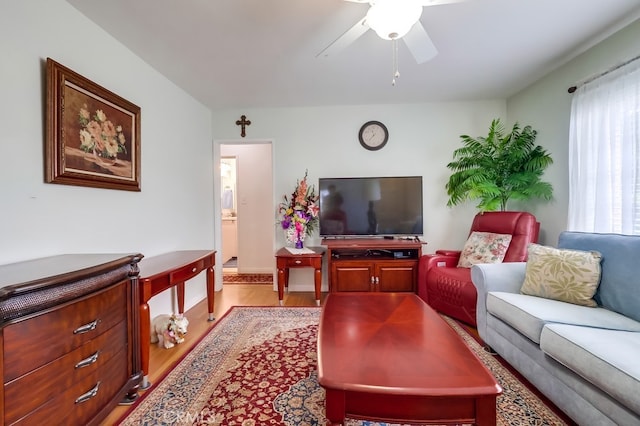 living area featuring wood finished floors and a ceiling fan