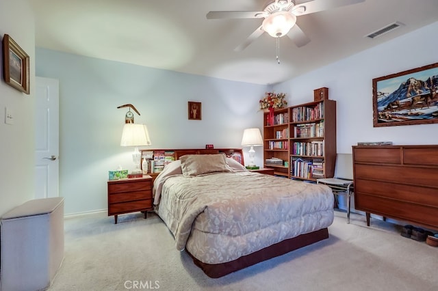 bedroom featuring light carpet, baseboards, and a ceiling fan