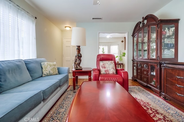living area featuring ceiling fan and wood finished floors