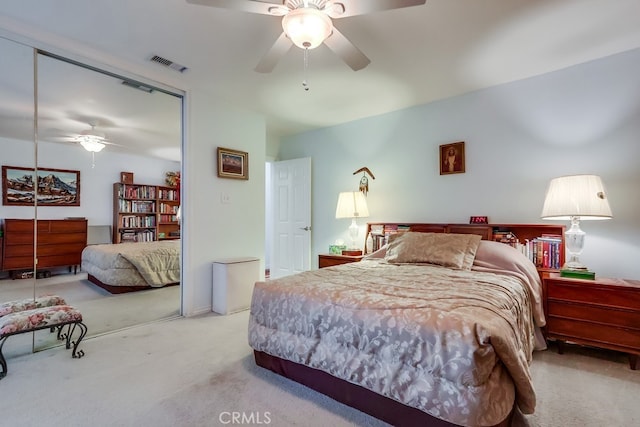 carpeted bedroom with a closet and ceiling fan