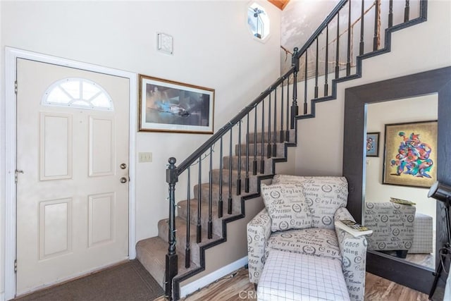 8269 Lost Mill Rd, Shingletown, CA 96088 - entrance foyer with stairs, healthy amount of natural light, a towering ceiling, and wood finished floors
