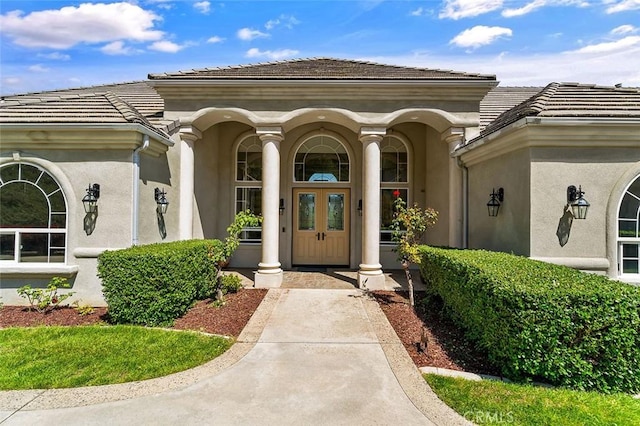 41653 Oak Trail Ct, Murrieta, CA 92562 - view of exterior entry featuring stucco siding, a tiled roof, and covered porch