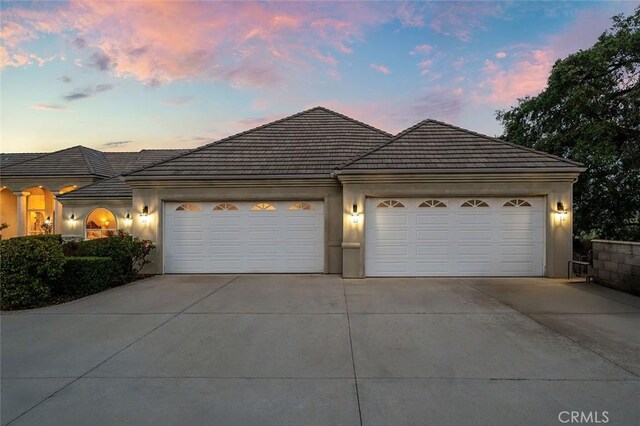 41653 Oak Trail Ct, Murrieta, CA 92562 - view of front facade with concrete driveway, a garage, a tile roof, and stucco siding
