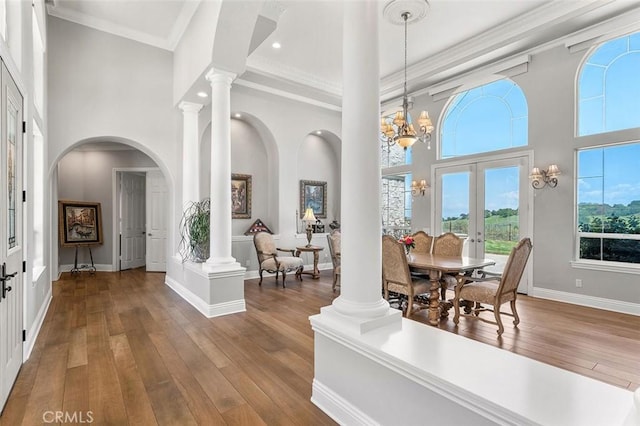 41653 Oak Trail Ct, Murrieta, CA 92562 - dining space with french doors, a high ceiling, ornamental molding, wood-type flooring, and plenty of natural light