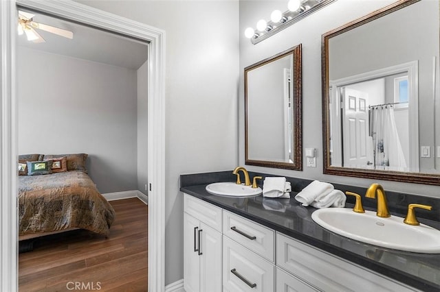 41653 Oak Trail Ct, Murrieta, CA 92562 - bathroom featuring wood finished floors, baseboards, and double vanity