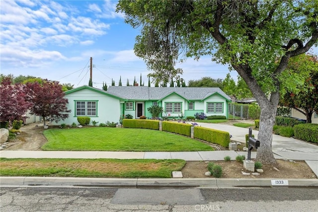 ranch-style home featuring a front yard