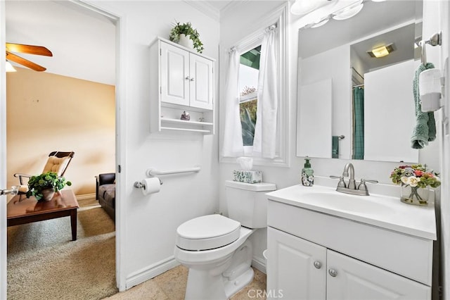 bathroom with toilet, ceiling fan, vanity, ornamental molding, and baseboards