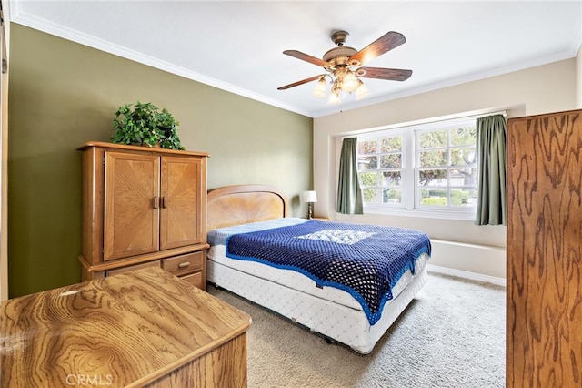 bedroom featuring crown molding, light carpet, and a ceiling fan