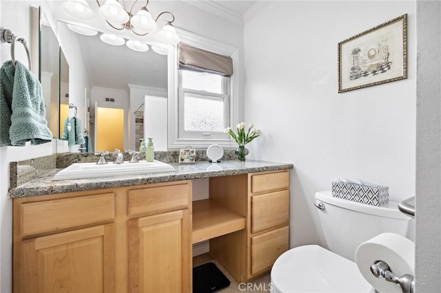 bathroom featuring toilet, ornamental molding, vanity, and a chandelier