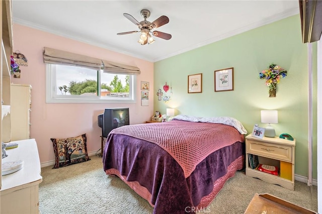 carpeted bedroom featuring crown molding, baseboards, and ceiling fan