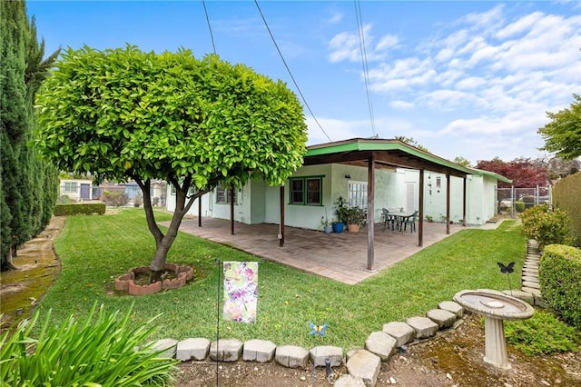 rear view of property with a patio and stucco siding