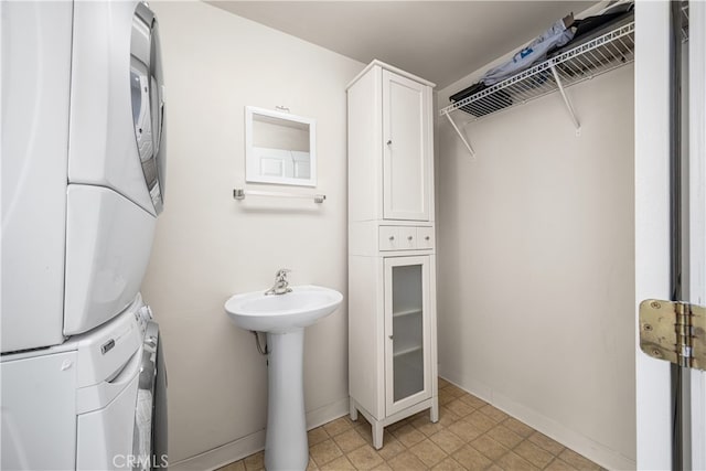 3113 San Anseline Ave, Long Beach, CA 90808 - bathroom featuring stacked washer and clothes dryer, baseboards, and a sink