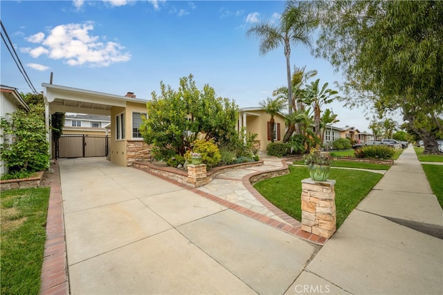 3113 San Anseline Ave, Long Beach, CA 90808 - view of front of property with driveway, a carport, stucco siding, a front lawn, and a gate