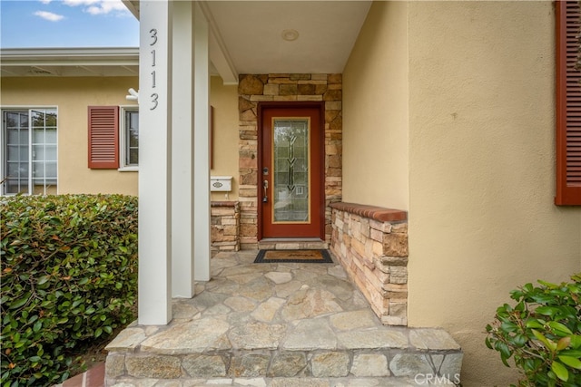 3113 San Anseline Ave, Long Beach, CA 90808 - view of exterior entry featuring stone siding and stucco siding